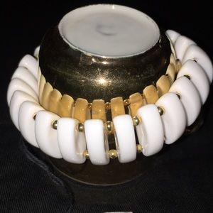White oval lucite and gold beaded bracelet.